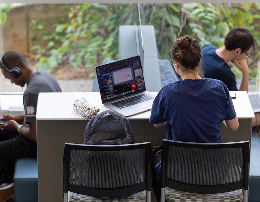 ksu students focused on their laptops studying.